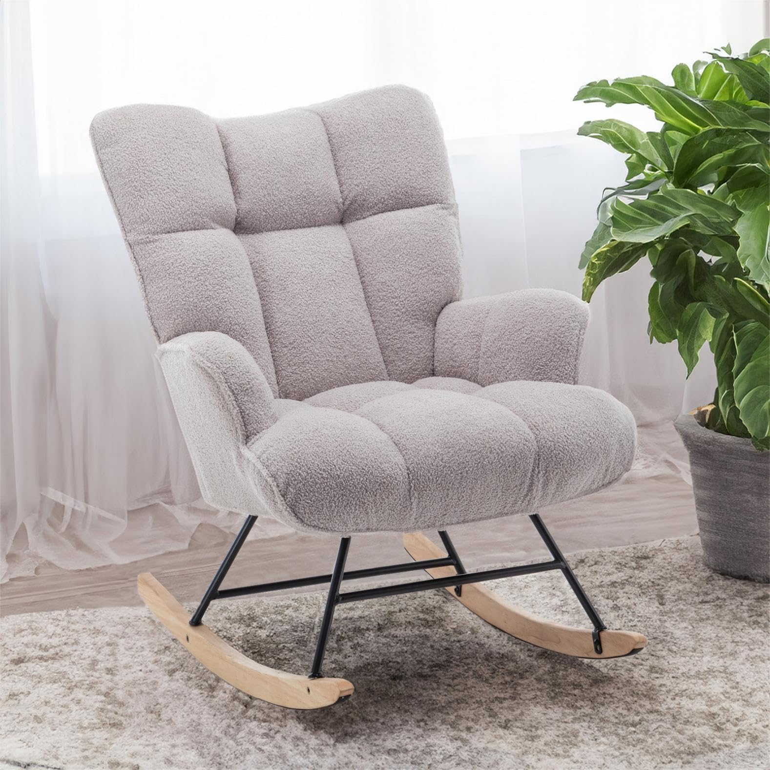 Modern gray nursery glider and ottoman placed in minimal baby room