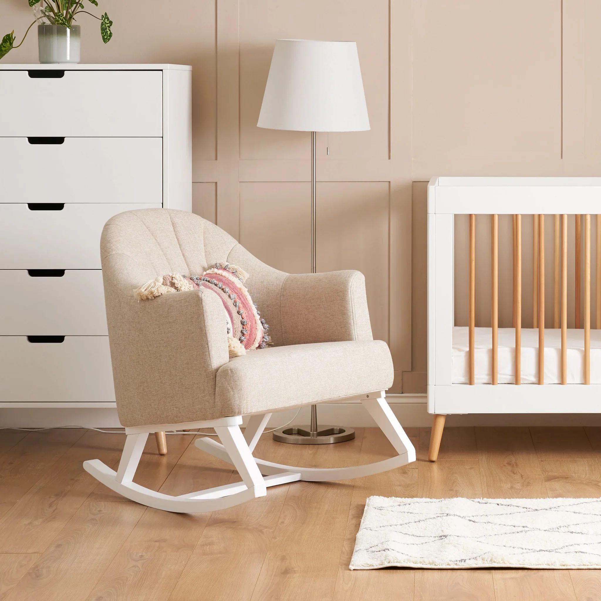 Compact round-back glider chair in a bright cozy baby room
